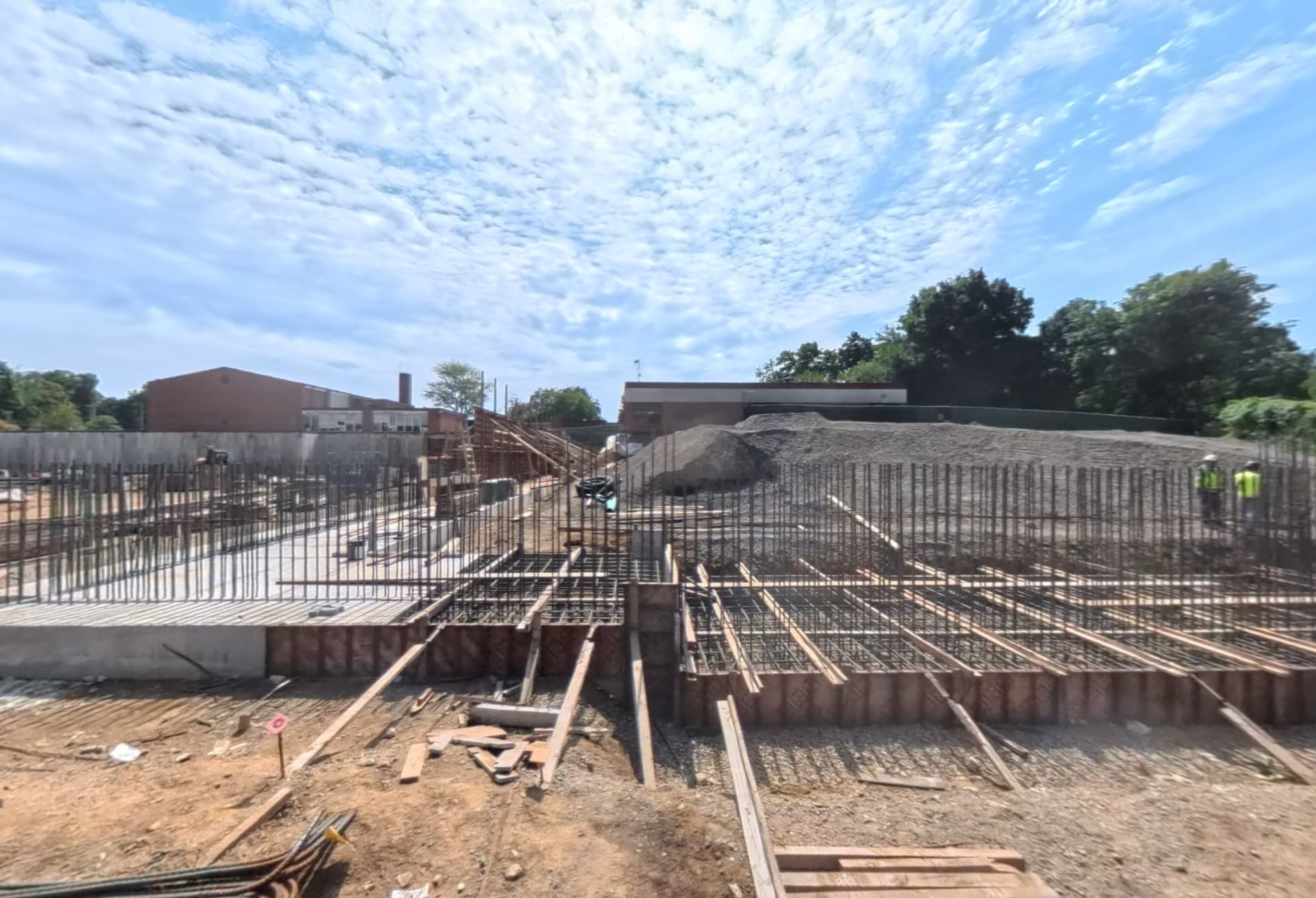 September 2026 — Reinforcing steel and formwork prepared at gymnasium entrance