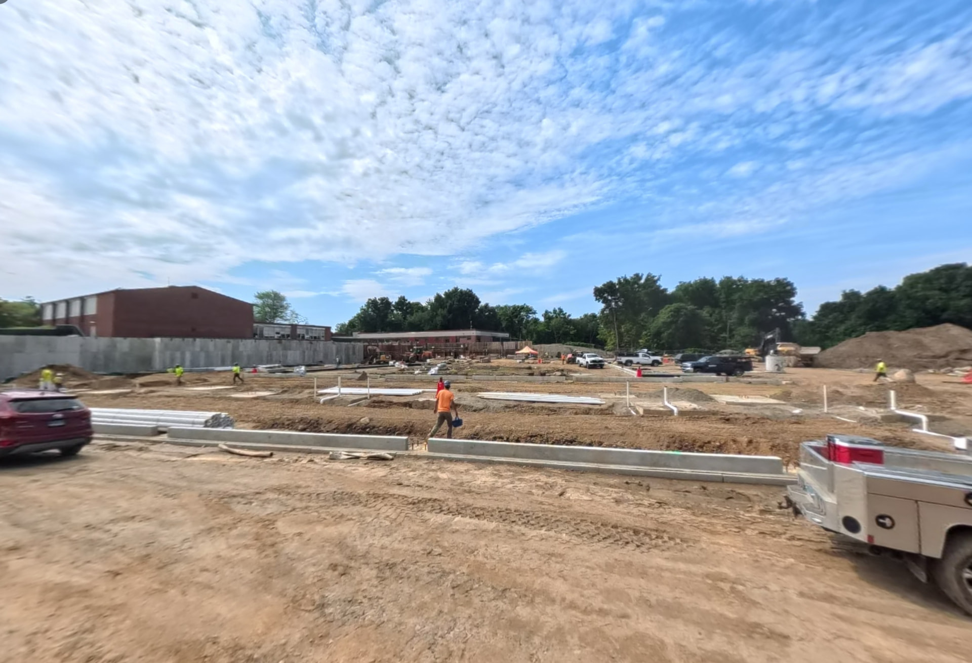September 2026 — Underground plumbing and utility lines installed across the building footprint ahead of slab preparation
