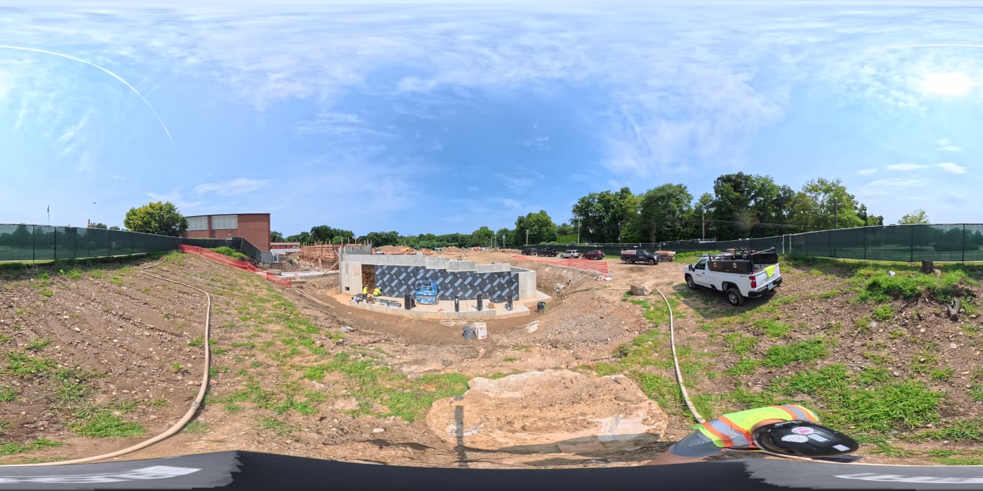 August 2026 — Wide view of the foundation and waterproofed walls at the southeast corner of the new building
