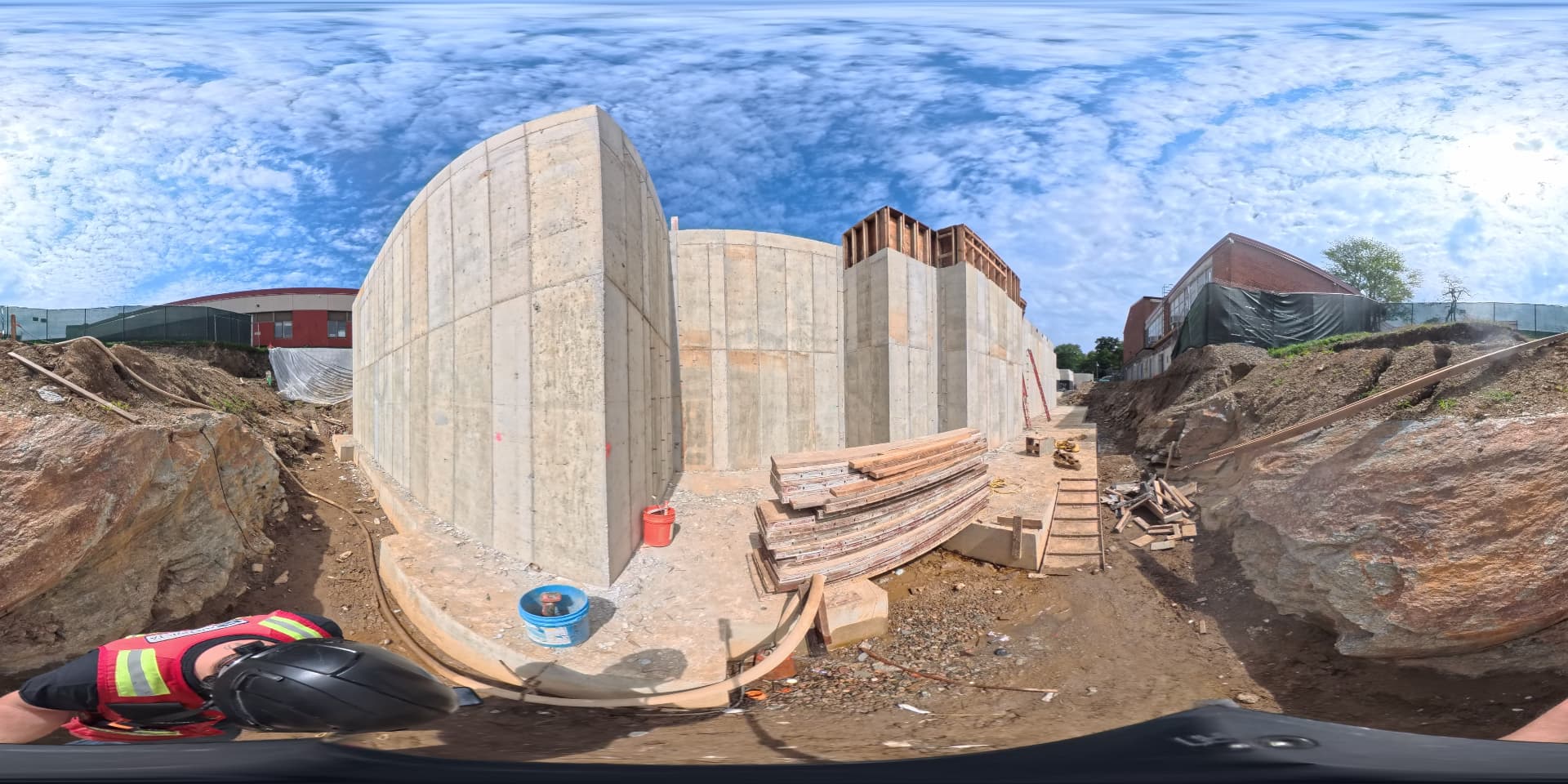 September 2026 — Concrete foundation walls with formwork and bracing stacked at the southwest corner near future Stepping Stones entrance